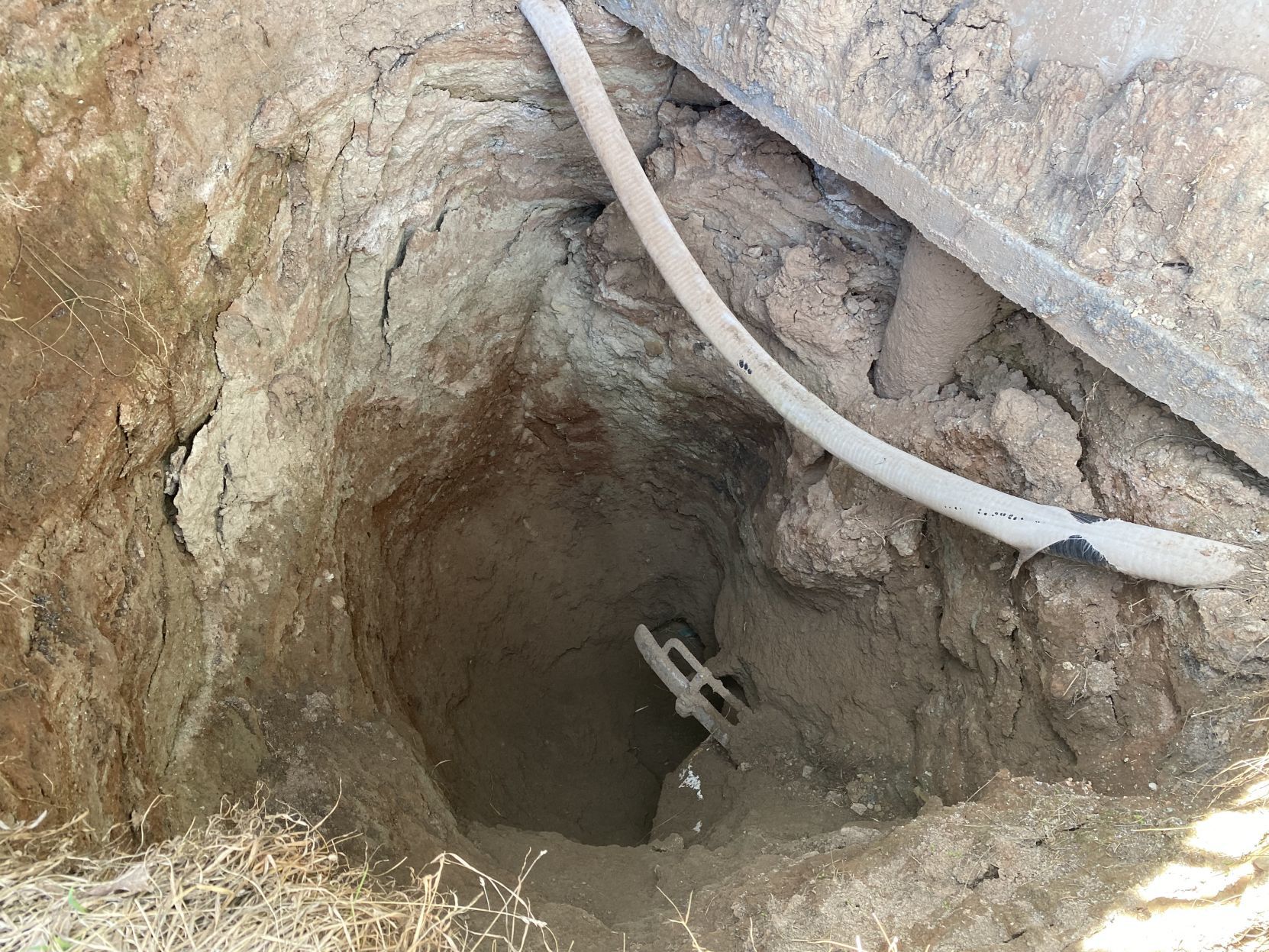 A vehicle bumper in a smaller sinkhole